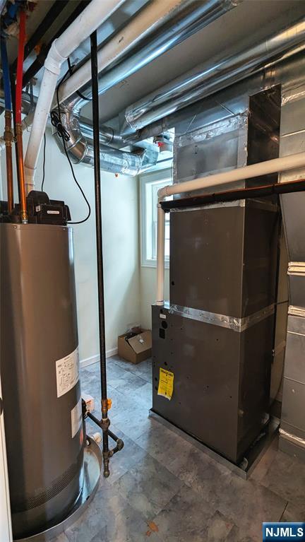7 Maple Street, Unit 1 Bloomfield, NJ 07003 - Photo 7 of 19 a room with water heater and wooden cabinets