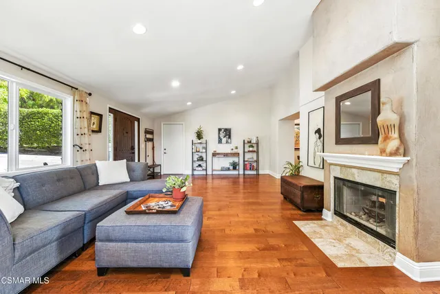 a living room with furniture and a fireplace