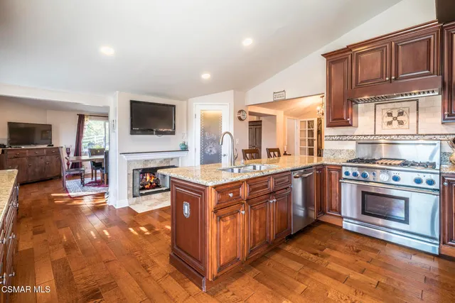 a kitchen with granite countertop a stove and a sink