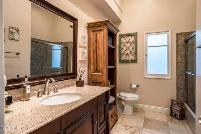 a bedroom with a bed and a fireplace