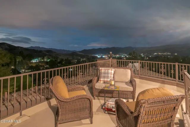 a view of a chair and table on the roof deck