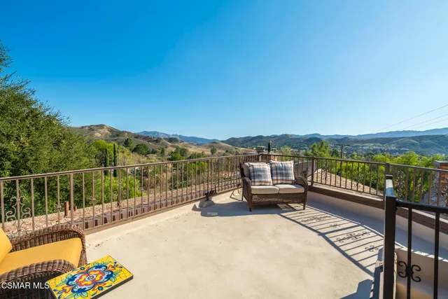 a view of two chairs in the balcony