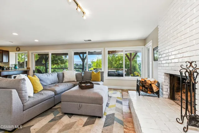 a view of a chairs and table in the backyard