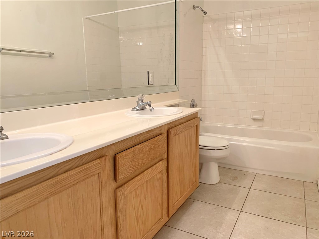 3821 Bombastic Court Las Vegas, NV 89147 - Photo 16 of 36 This bathroom features a double vanity with ample counter space and a classic tub and shower combination.