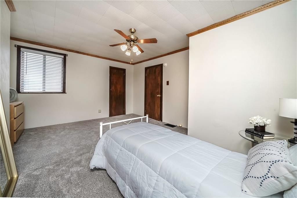 805 Frank Street McKees Rocks, PA 15136 - Photo 17 of 25 a bedroom with a large bed and a chandelier