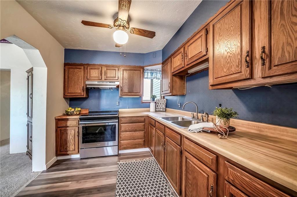 805 Frank Street McKees Rocks, PA 15136 - Photo 5 of 25 a kitchen with stainless steel appliances granite countertop a stove a sink and a refrigerator
