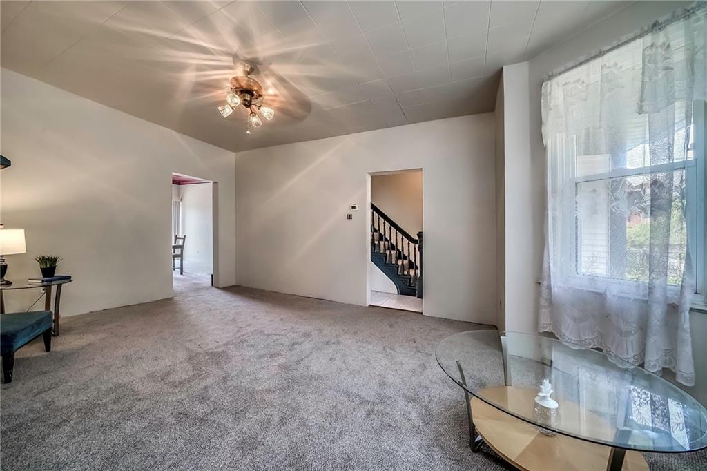 805 Frank Street McKees Rocks, PA 15136 - Photo 10 of 25 a view of a livingroom with a chandelier fan and kitchen view