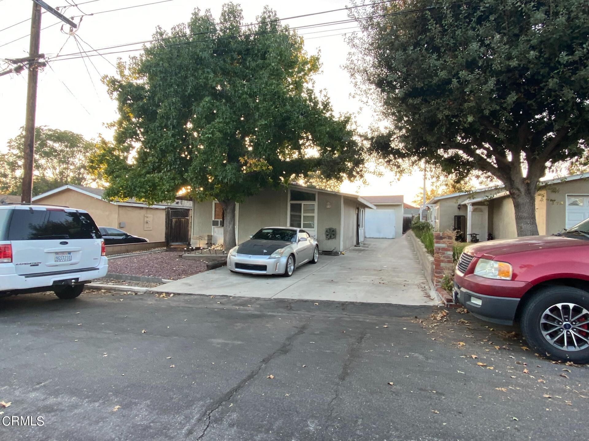 a car parked in front of a white house