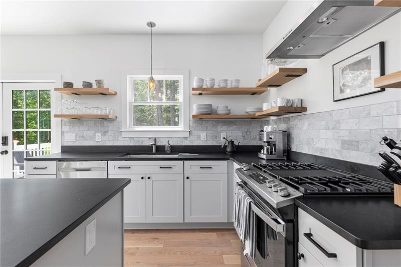 7600 Barnes Road Palmetto, GA 30268 - Photo 14 of 37 a kitchen with stainless steel appliances granite countertop a sink stove and cabinets