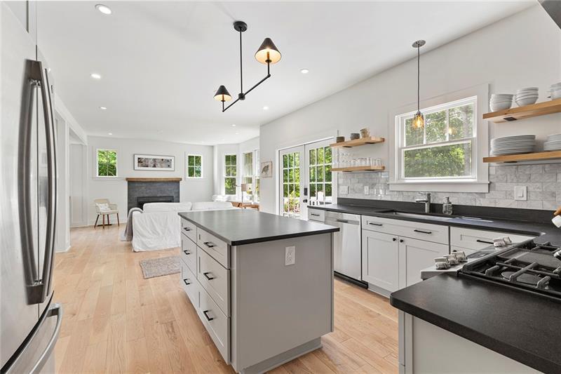 7600 Barnes Road Palmetto, GA 30268 - Photo 15 of 37 a kitchen with kitchen island granite countertop a stove and a sink