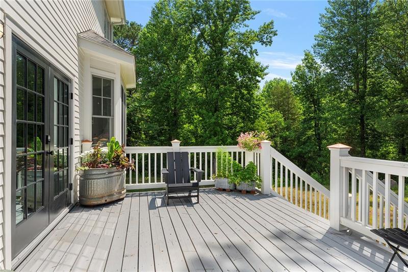 7600 Barnes Road Palmetto, GA 30268 - Photo 35 of 37 a view of a deck with couches table and chairs and wooden floor