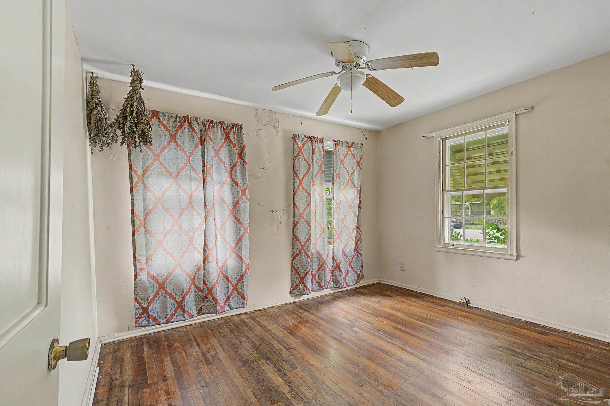 333 Gibbs Road Pensacola, FL 32507 - Photo 16 of 34 a view of empty room with wooden floor and fan