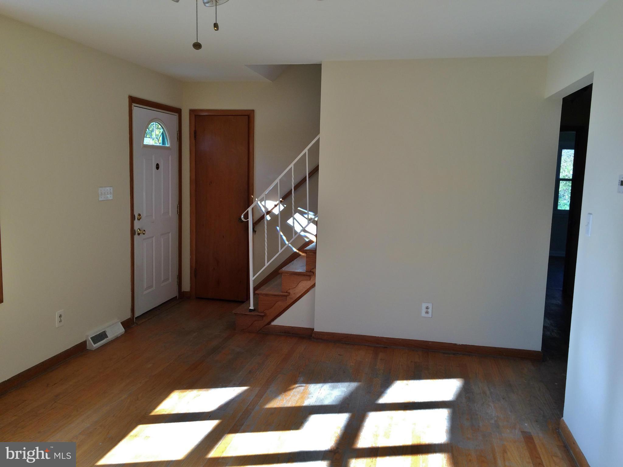 2115 Gaybrook Road Baltimore, MD 21244 - Photo 3 of 10 a view of an empty room with wooden floor and a window