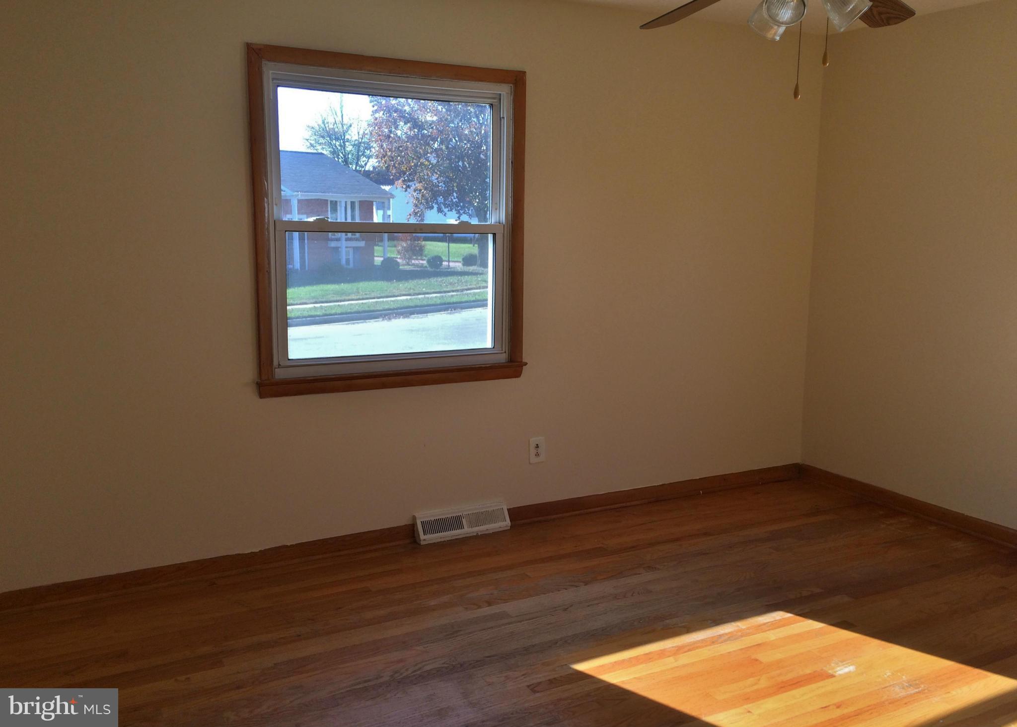 2115 Gaybrook Road Baltimore, MD 21244 - Photo 6 of 10 an empty room with wooden floor and a window
