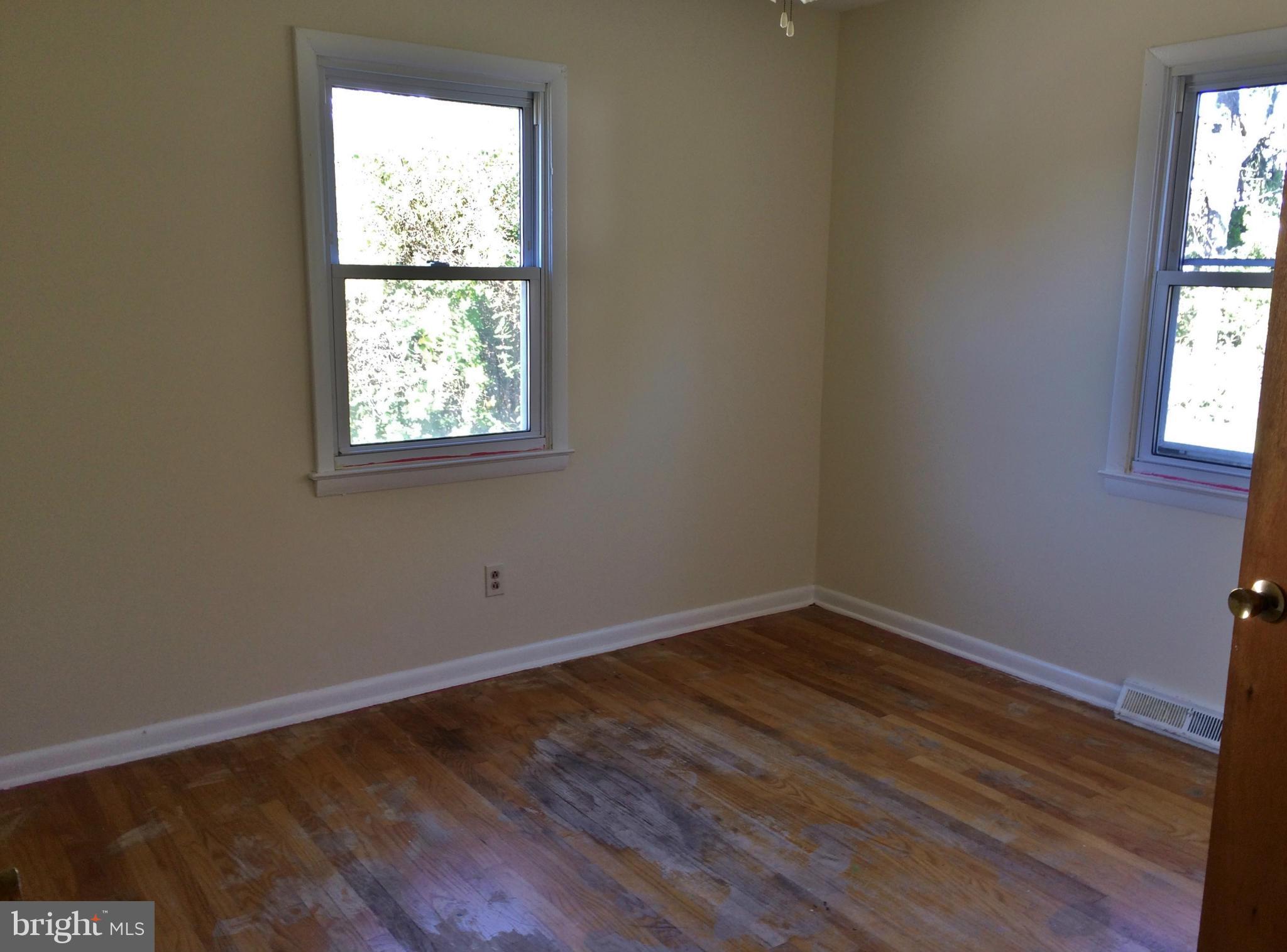 2115 Gaybrook Road Baltimore, MD 21244 - Photo 7 of 10 an empty room with wooden floor and windows