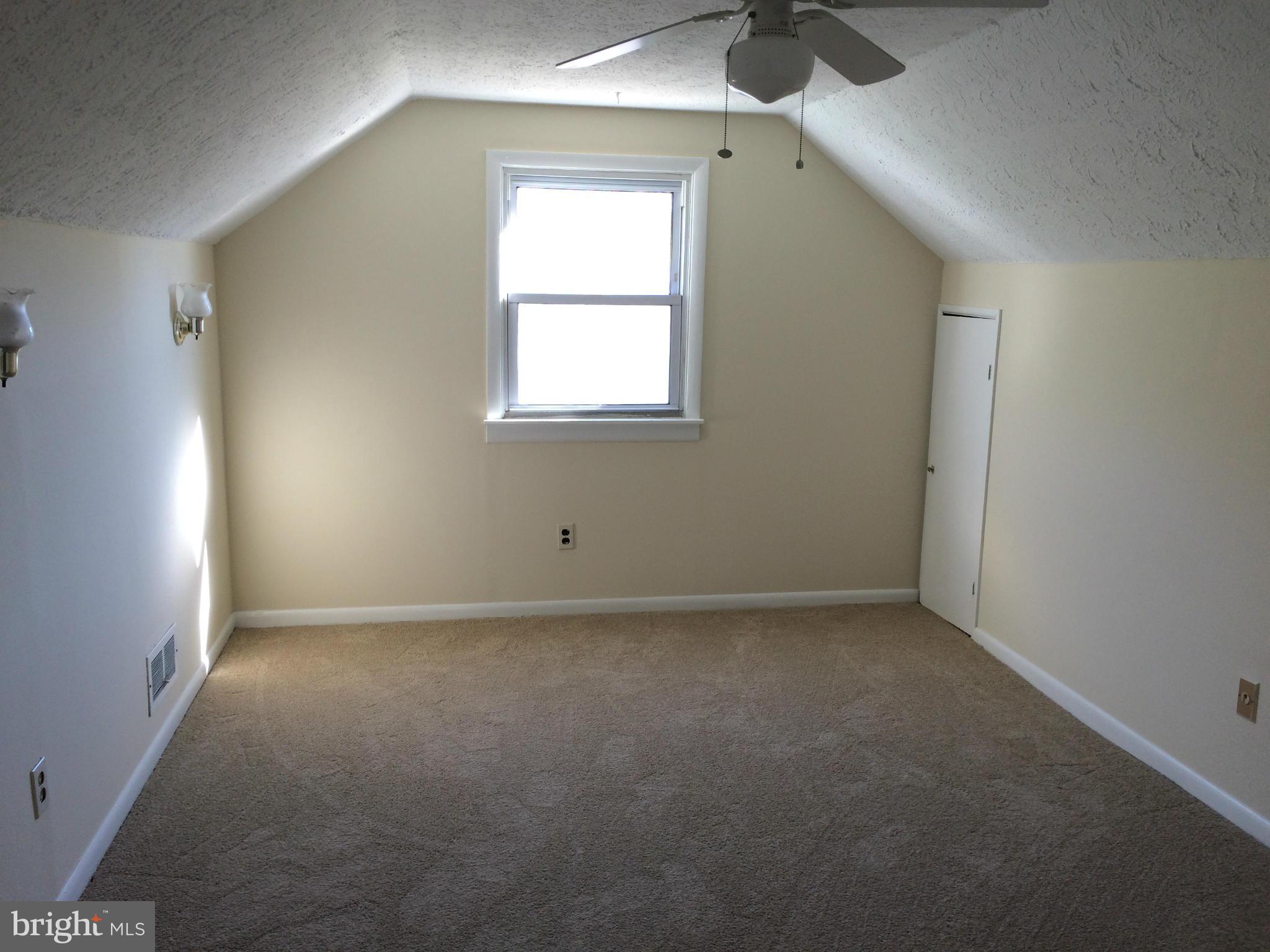 2115 Gaybrook Road Baltimore, MD 21244 - Photo 8 of 10 an empty room with a window and a fan