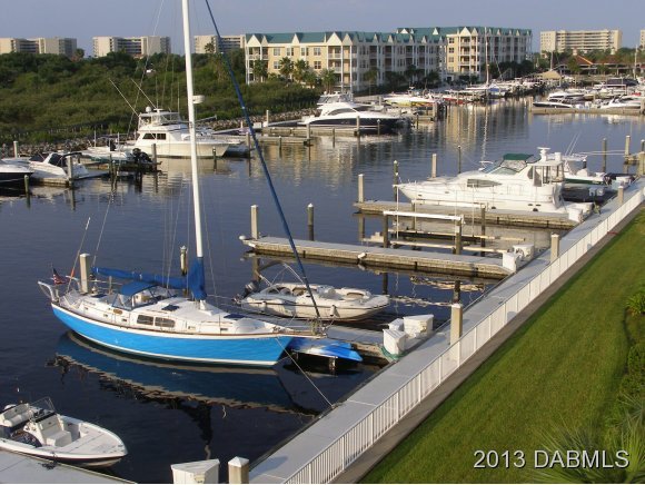 4623 Rivers Edge Village Lane, Unit 6208 Ponce Inlet, FL 32127 - Photo 13 of 23 a view of a lake with a table and chairs