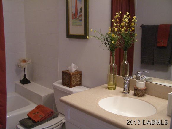 4623 Rivers Edge Village Lane, Unit 6208 Ponce Inlet, FL 32127 - Photo 17 of 23 a bathroom with a sink and a mirror