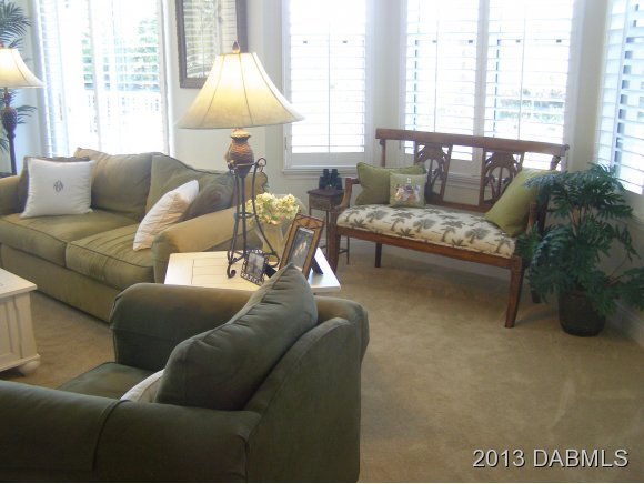 4623 Rivers Edge Village Lane, Unit 6208 Ponce Inlet, FL 32127 - Photo 19 of 23 a living room with furniture and a large window