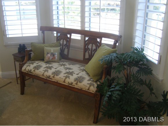 4623 Rivers Edge Village Lane, Unit 6208 Ponce Inlet, FL 32127 - Photo 21 of 23 a bed sitting in a bedroom next to a window