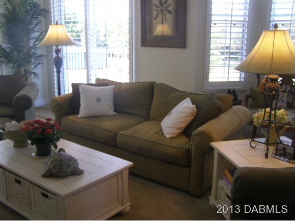 4623 Rivers Edge Village Lane, Unit 6208 Ponce Inlet, FL 32127 - Photo 3 of 23 a living room with furniture and a window