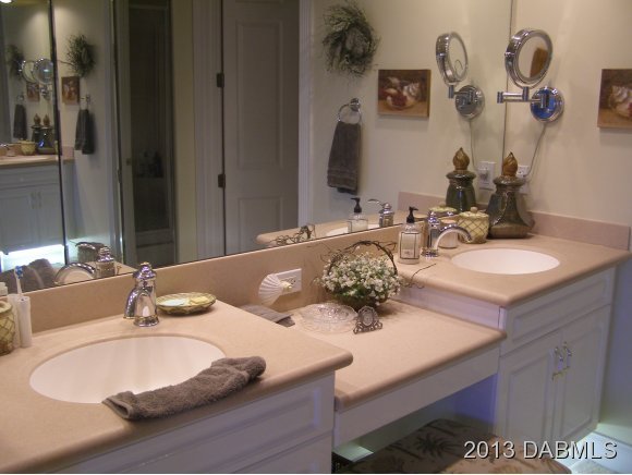 4623 Rivers Edge Village Lane, Unit 6208 Ponce Inlet, FL 32127 - Photo 7 of 23 a bathroom with a double vanity sink and a mirror