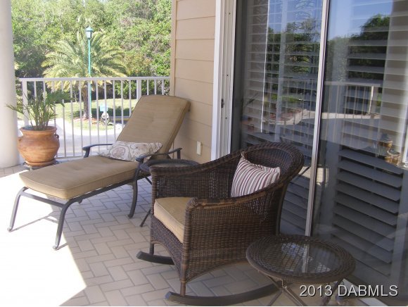 4623 Rivers Edge Village Lane, Unit 6208 Ponce Inlet, FL 32127 - Photo 9 of 23 a view of a porch with furniture