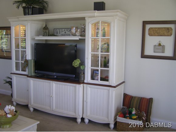 4623 Rivers Edge Village Lane, Unit 6208 Ponce Inlet, FL 32127 - Photo 10 of 23 a living room with furniture and a fireplace