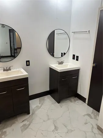 a bathroom with a sink vanity and mirror
