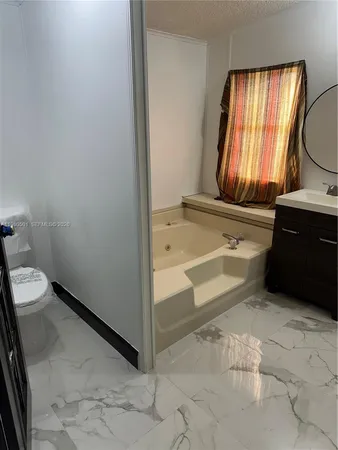 a bathroom with a bathtub and a window