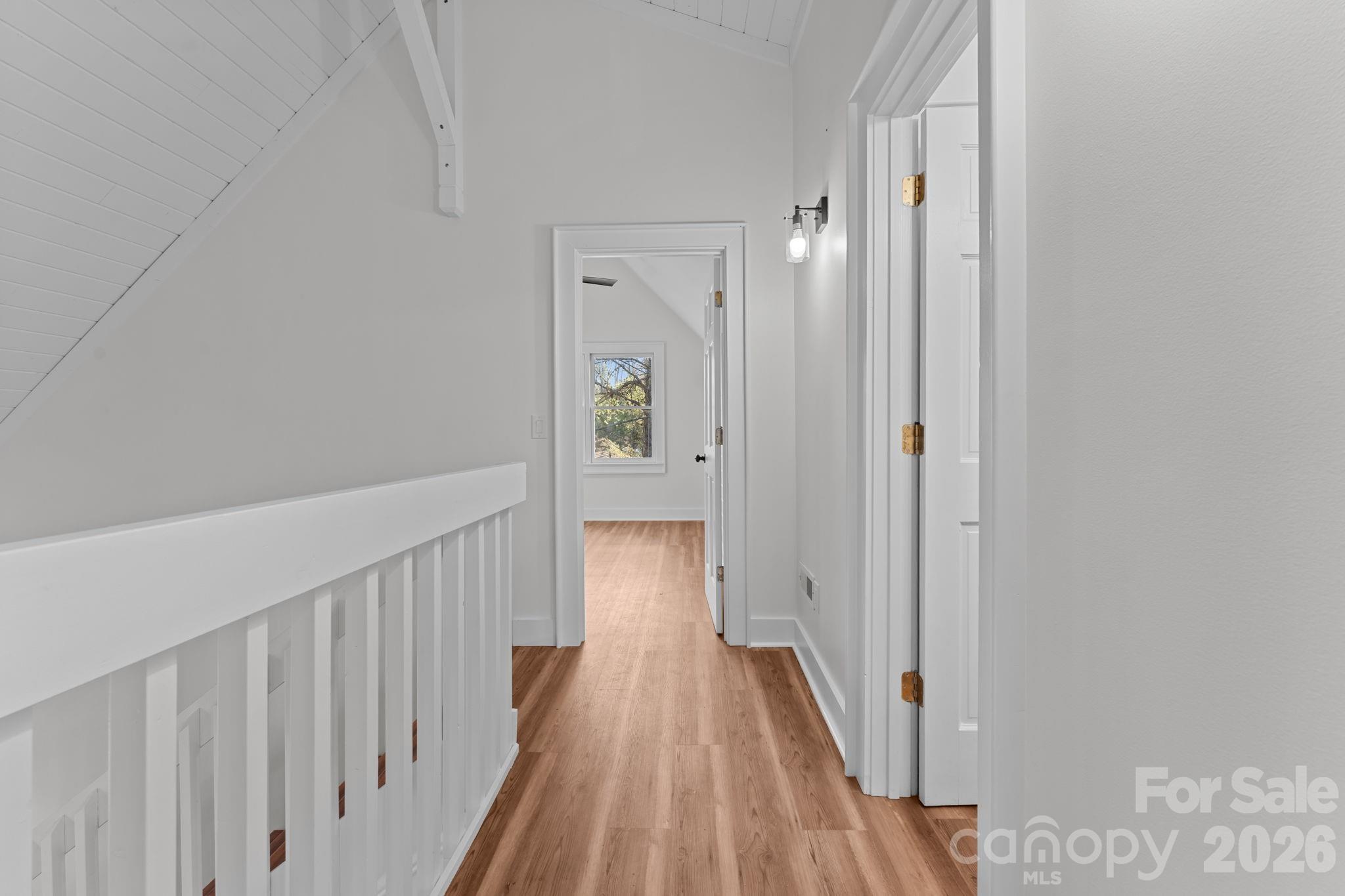 15 Glory Road Franklin, NC 28734 - Photo 17 of 37 a view of a hallway with wooden floor and a bathroom