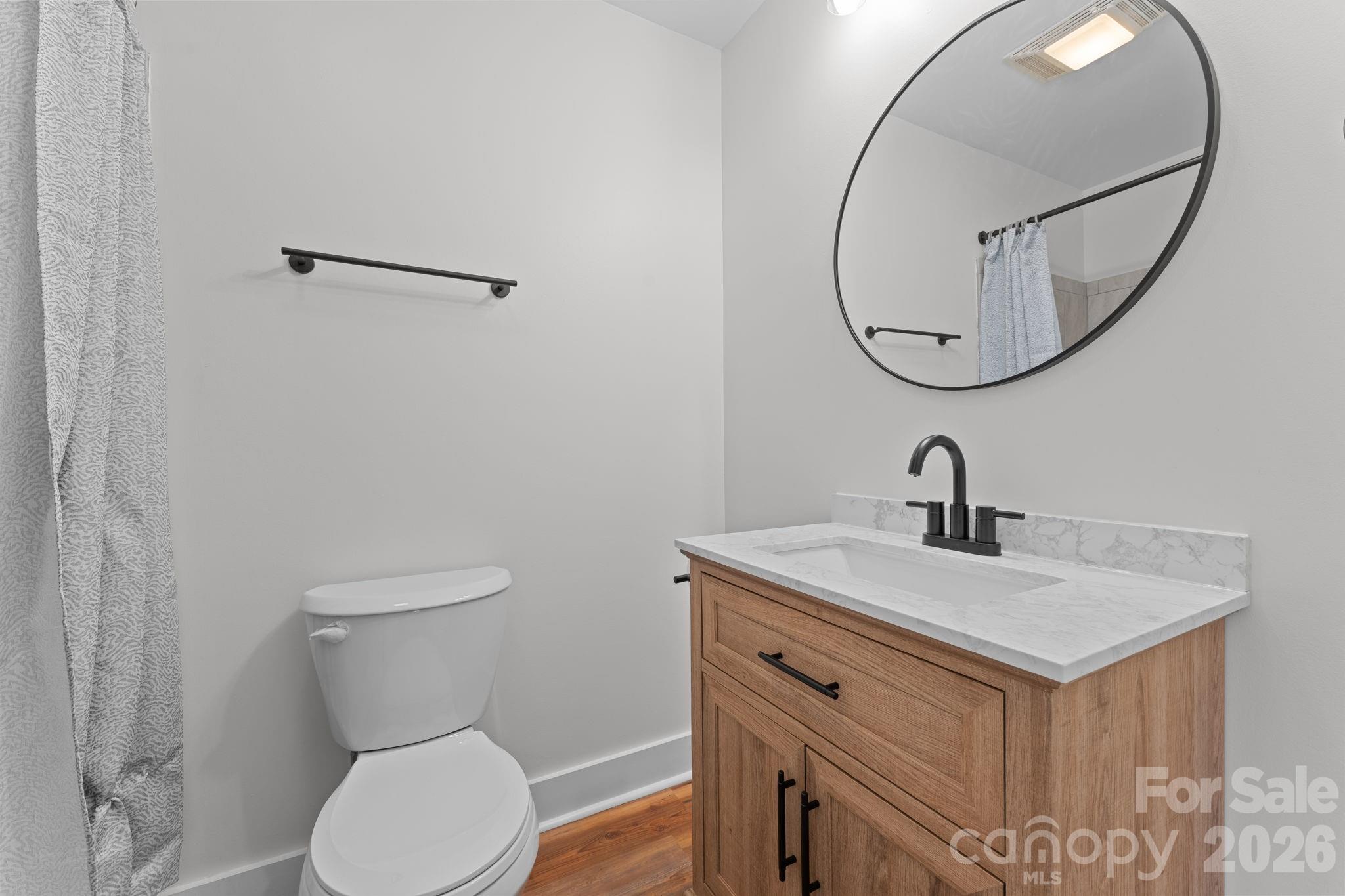 15 Glory Road Franklin, NC 28734 - Photo 25 of 37 a bathroom with a toilet sink and mirror