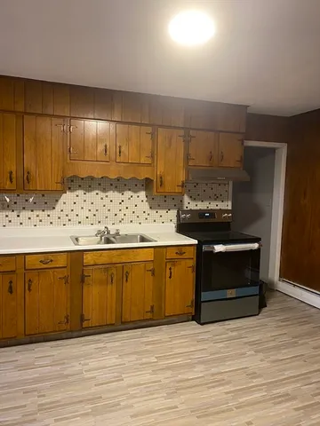 a view of kitchen with wooden floor