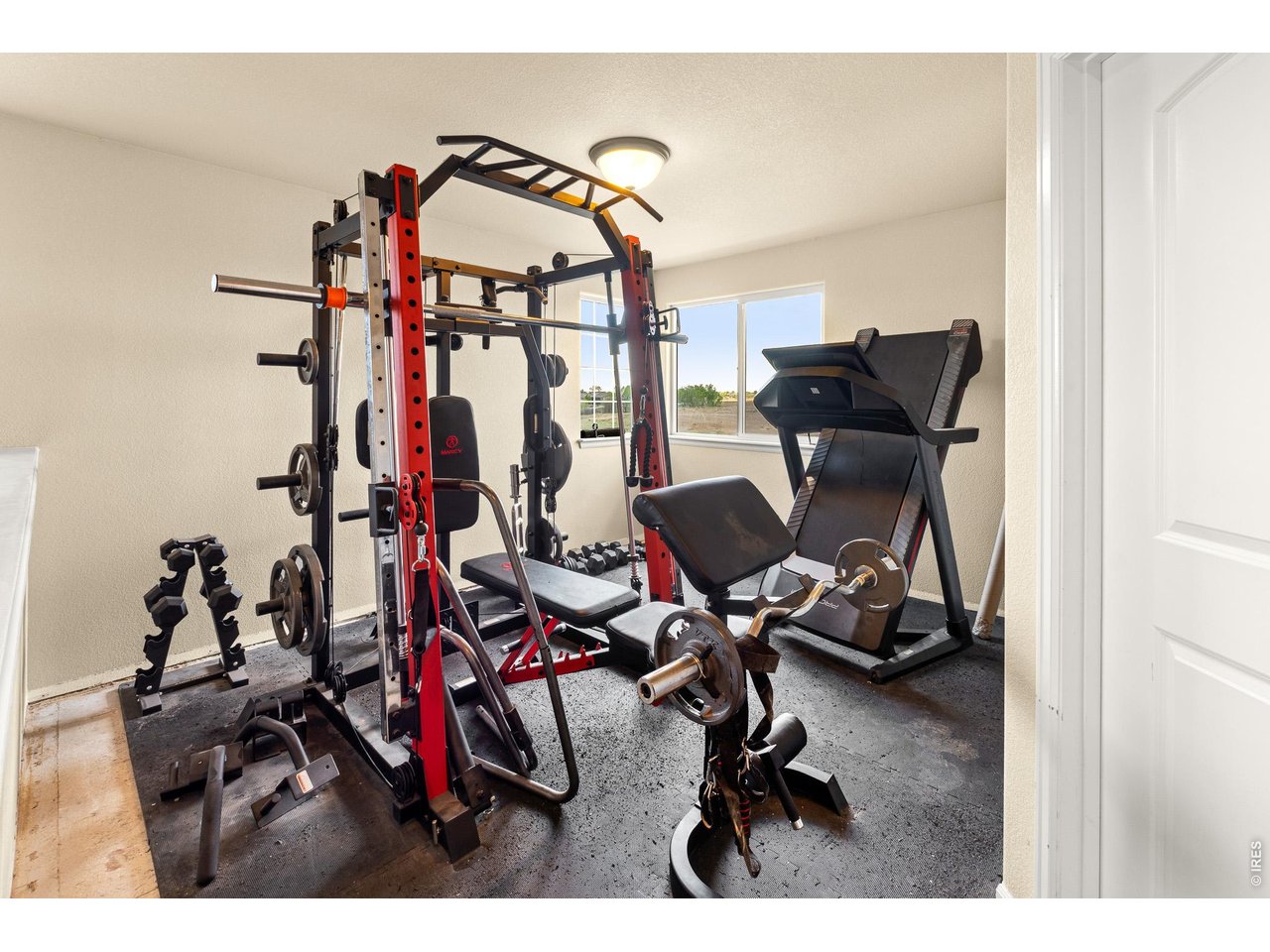 8847 16th St Road Greeley, CO 80634 - Photo 36 of 38 a view of a workspace with furniture and a gym cycle