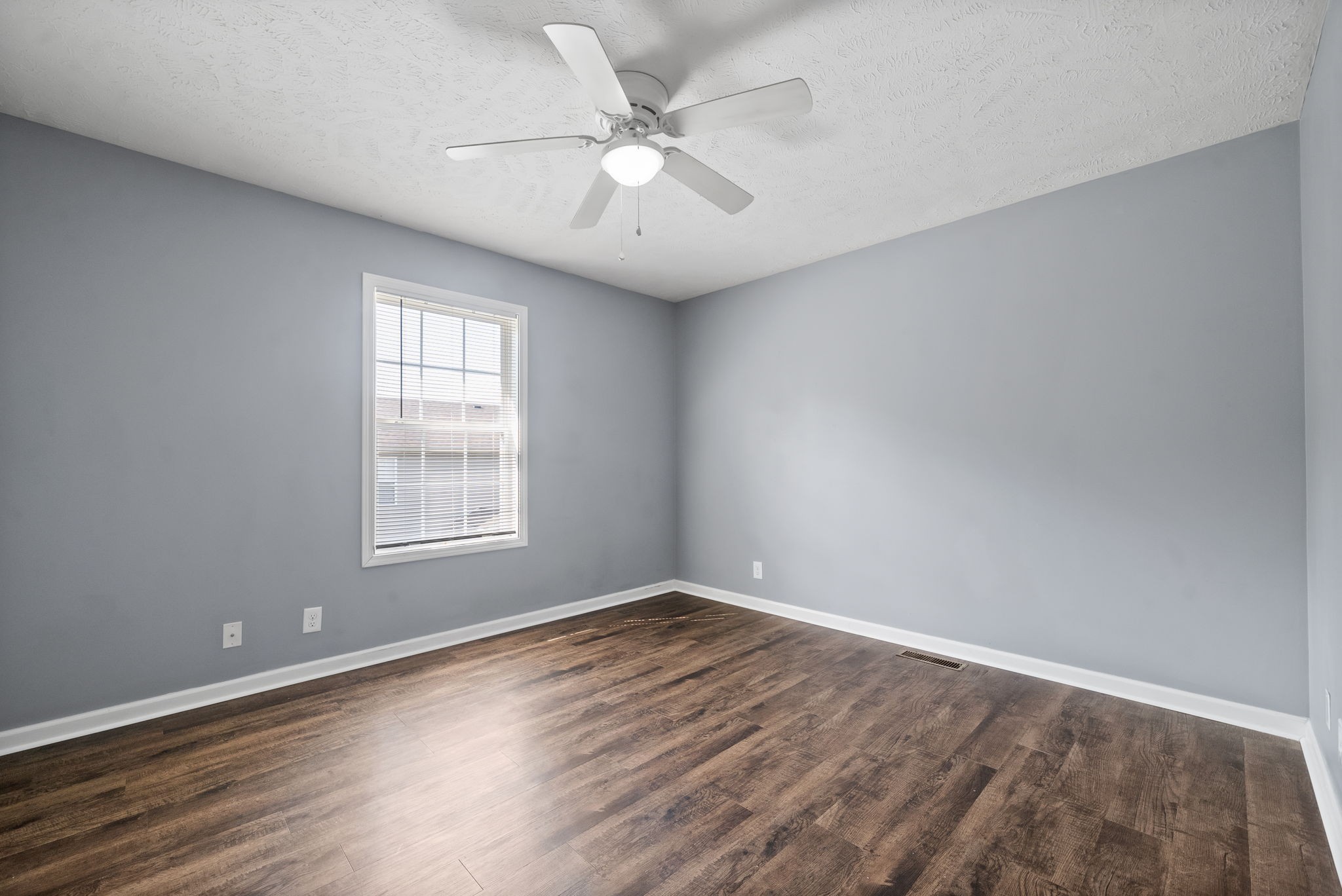 249 Executive Avenue, Unit B Clarksville, TN 37042 - Photo 11 of 13 an empty room with wooden floor and windows