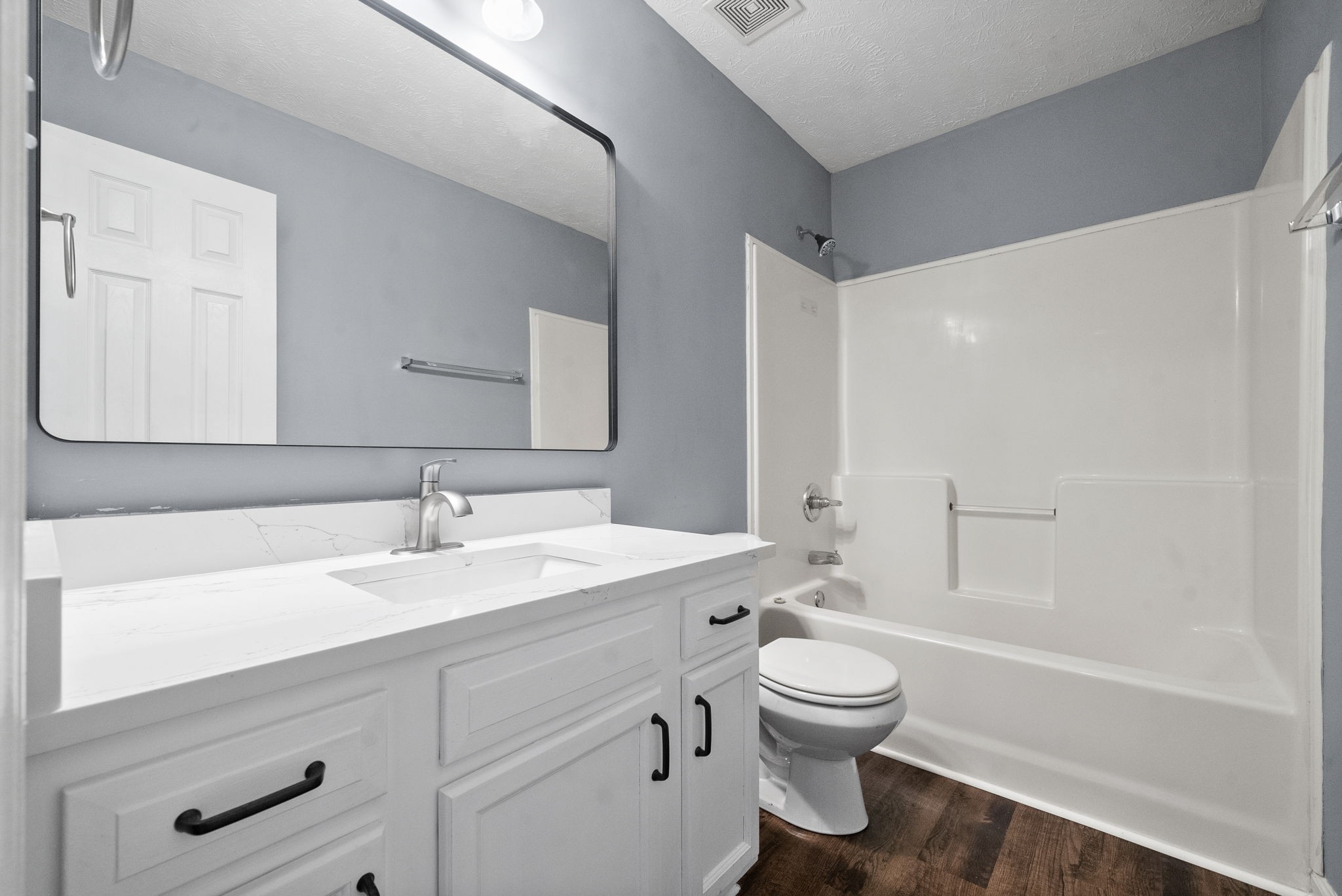 249 Executive Avenue, Unit B Clarksville, TN 37042 - Photo 12 of 13 a bathroom with a sink a toilet and a mirror