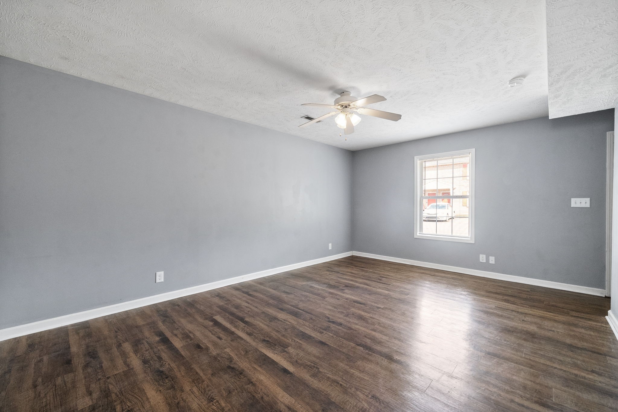 249 Executive Avenue, Unit B Clarksville, TN 37042 - Photo 4 of 13 a view of an empty room with a window and wooden floor