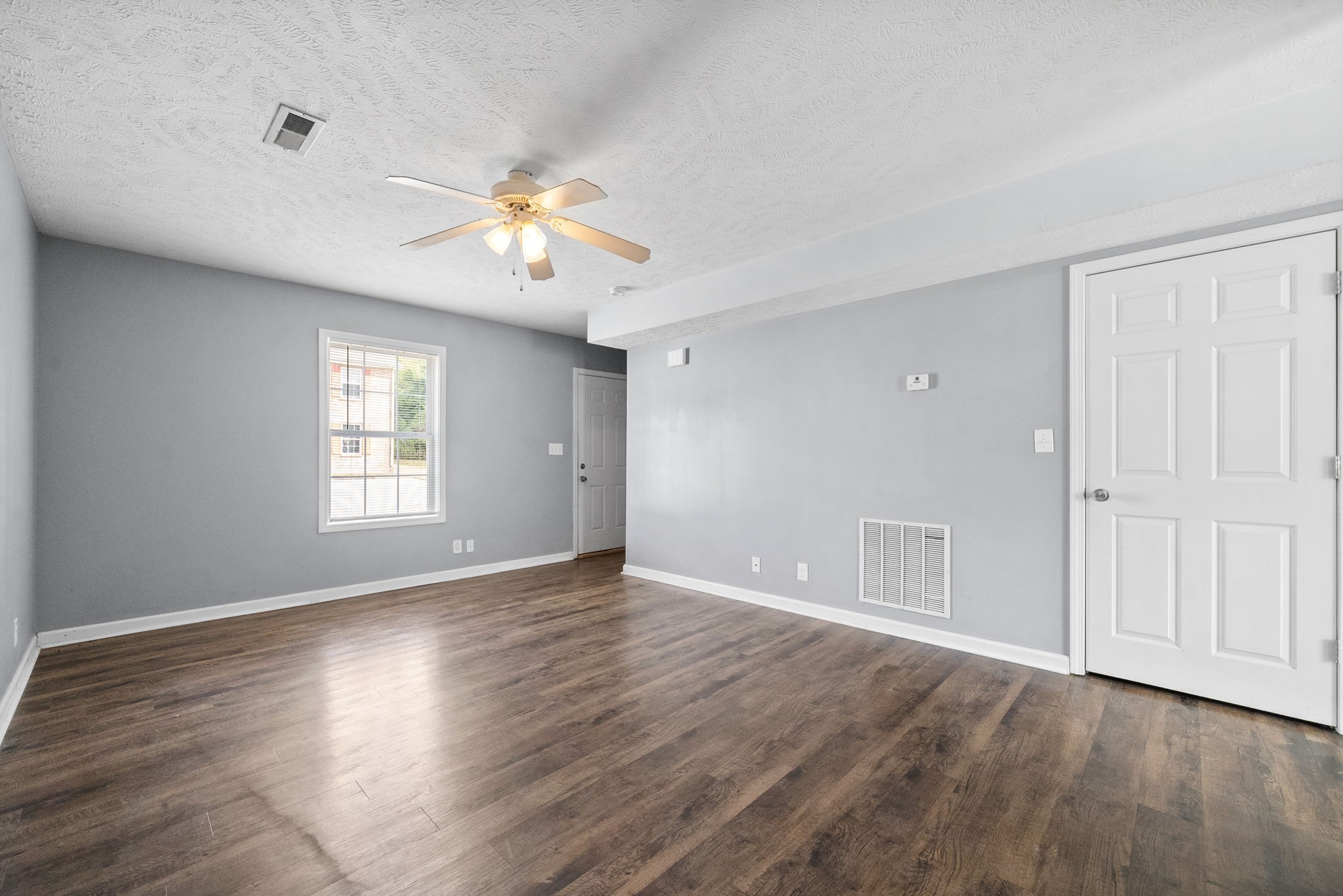 249 Executive Avenue, Unit B Clarksville, TN 37042 - Photo 5 of 13 a view of an empty room with a window and wooden floor