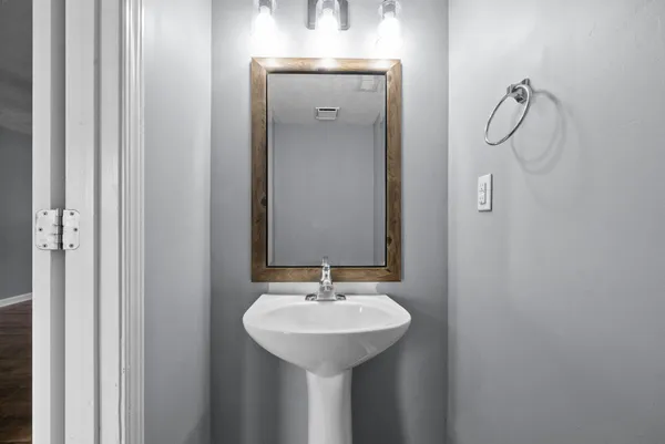 a bathroom with a sink and mirror
