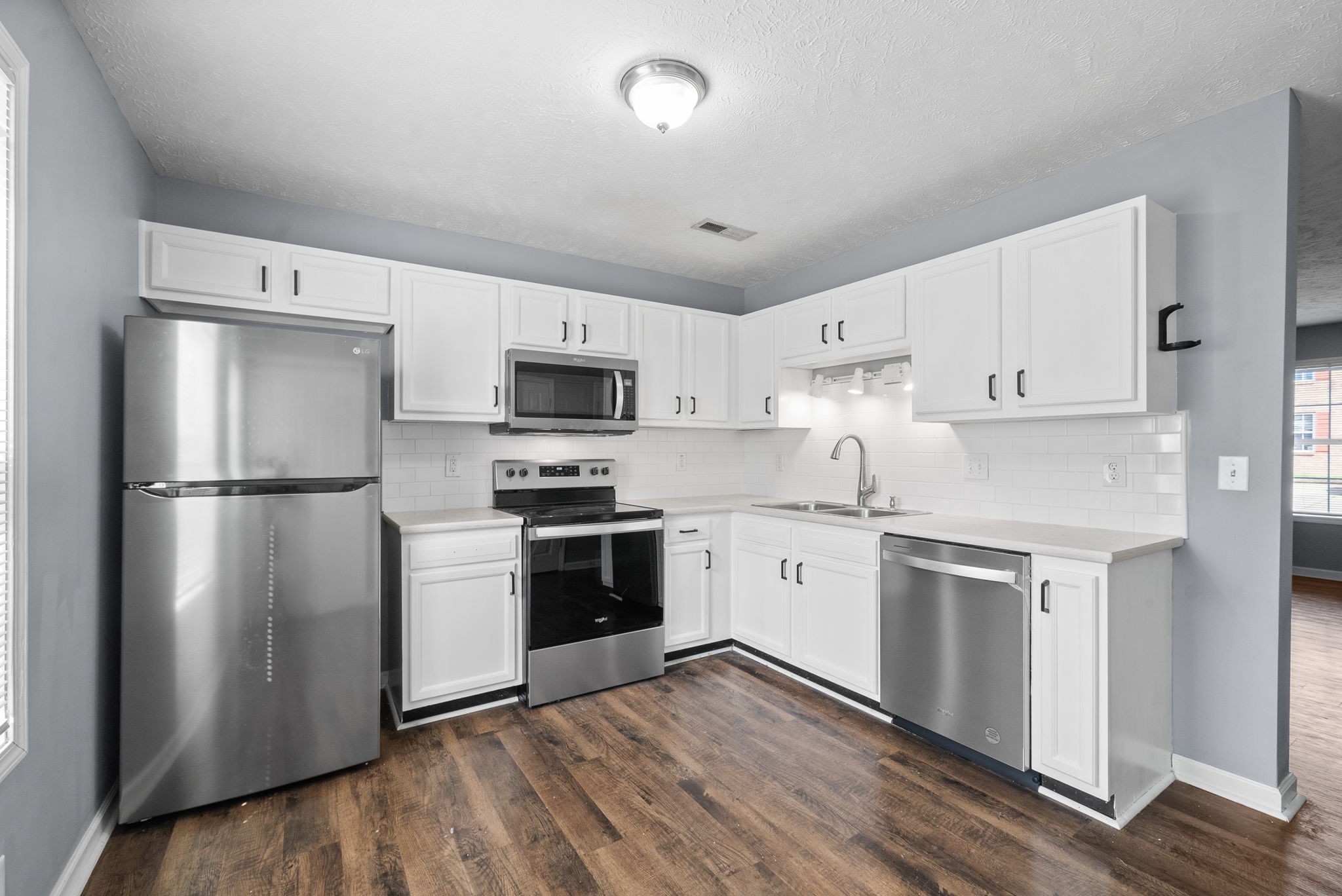 249 Executive Avenue, Unit B Clarksville, TN 37042 - Photo 7 of 13 a kitchen with granite countertop white cabinets and stainless steel appliances
