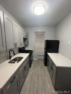 328 East 93rd Street, Unit 2F Brooklyn, NY 11212 - Photo 4 of 12 a kitchen with a cabinets and white appliances