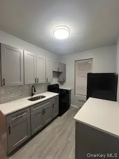 a kitchen with a sink and white cabinets