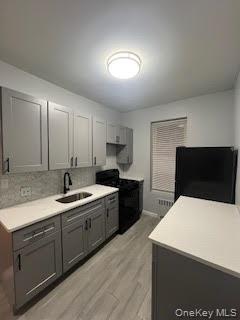 328 East 93rd Street, Unit 2F Brooklyn, NY 11212 - Photo 5 of 12 a kitchen with a sink and white cabinets
