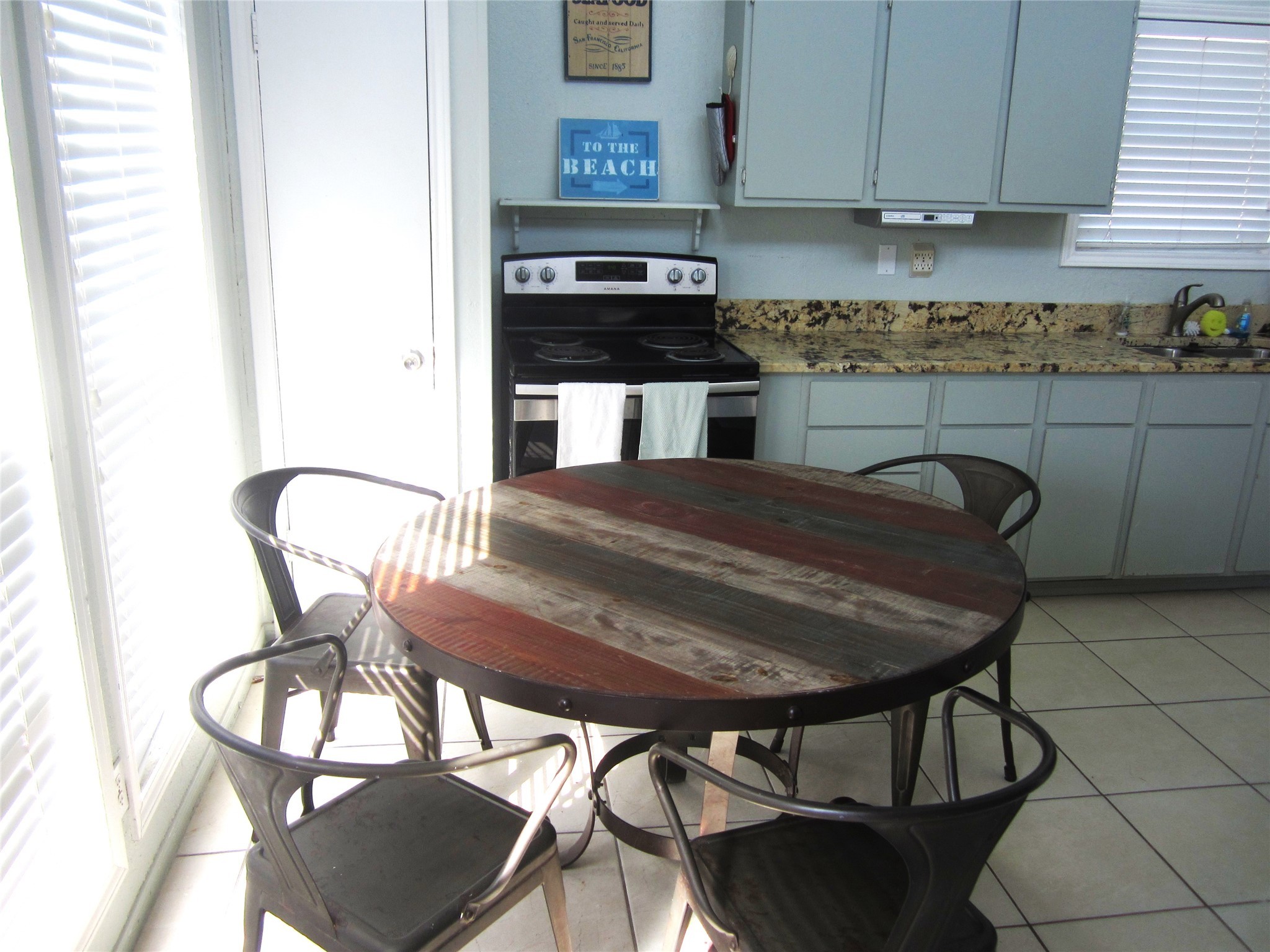 21639 Termini-San Luis Pass Road Galveston, TX 77554 - Photo 6 of 33 a kitchen with a table chairs and a stove