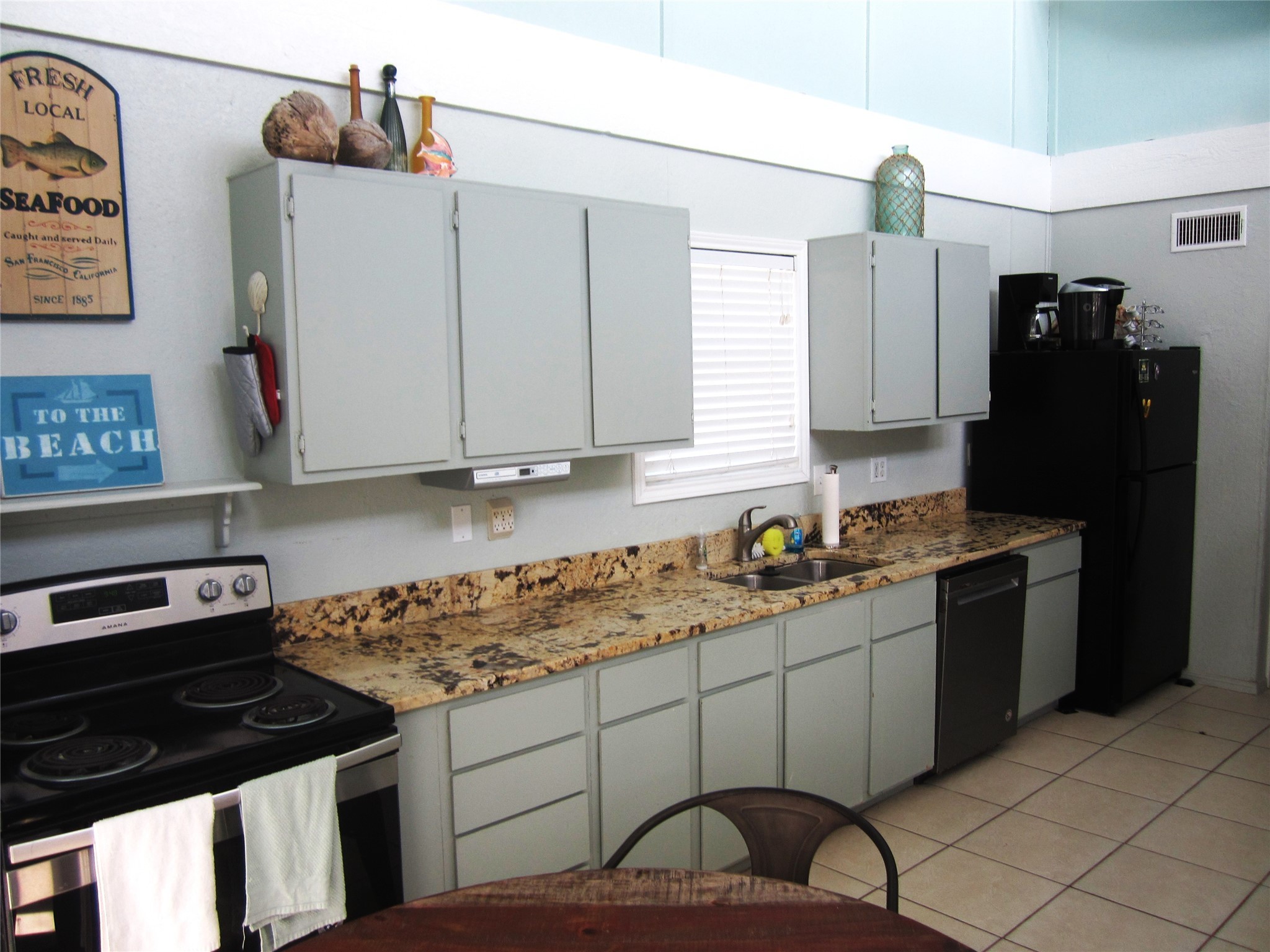 21639 Termini-San Luis Pass Road Galveston, TX 77554 - Photo 7 of 33 a kitchen with a sink a refrigerator and cabinets