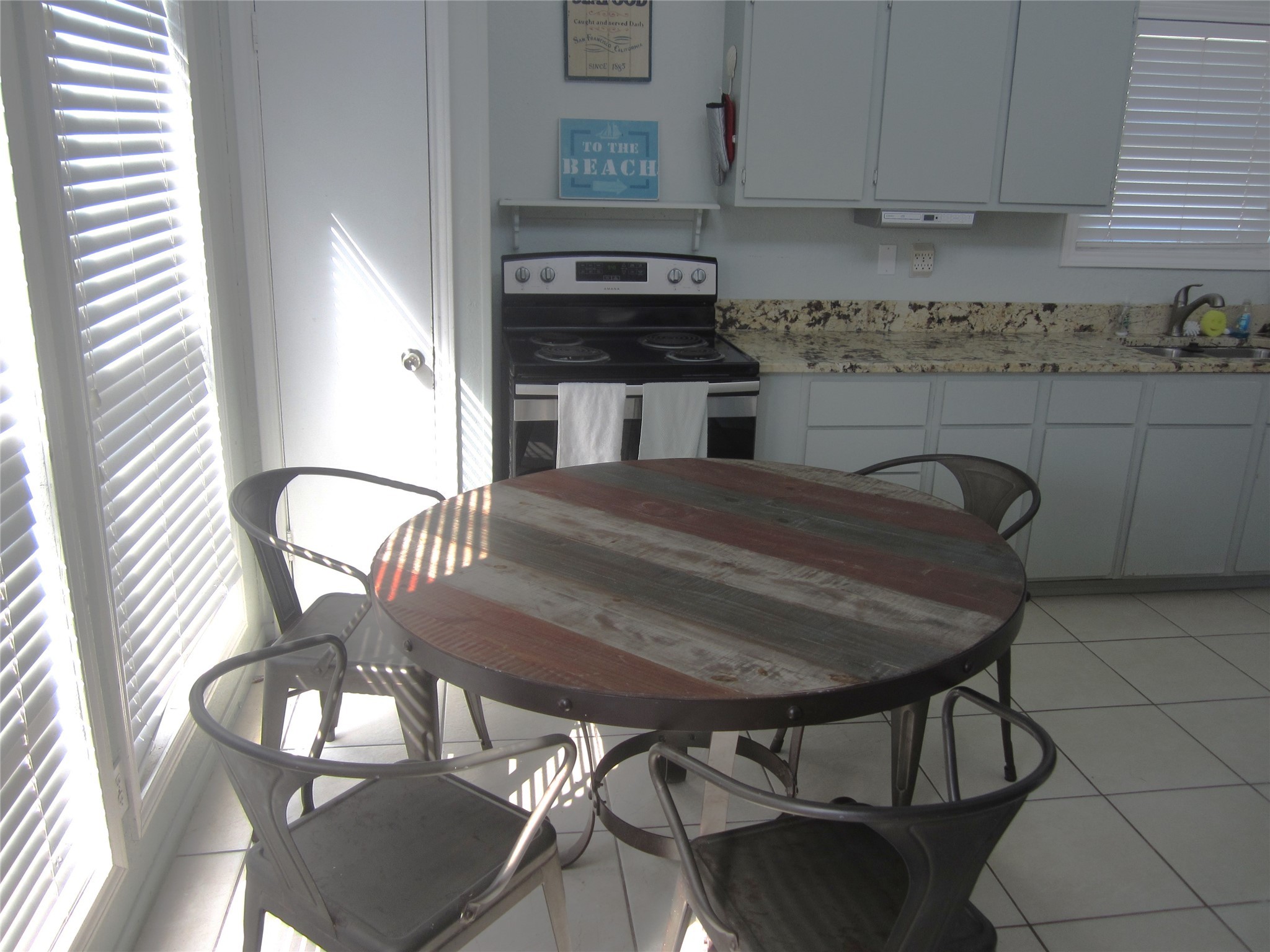 21639 Termini-San Luis Pass Road Galveston, TX 77554 - Photo 8 of 33 a kitchen with a table chairs and a stove