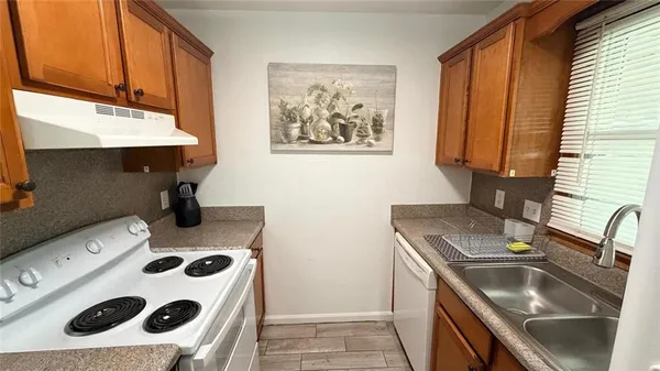 a kitchen with a sink a stove and a refrigerator