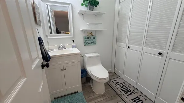 a bathroom with a toilet a sink and a mirror