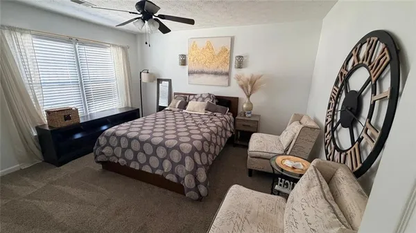 a bedroom with a bed couch and a window