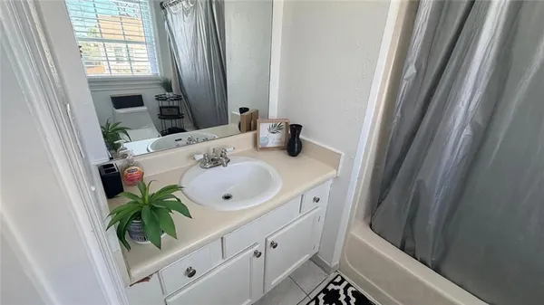 a bathroom with a sink a mirror and a shower